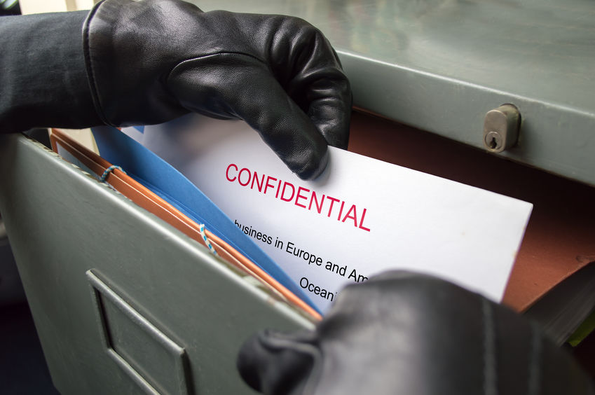 thief stealing confidential files in an office