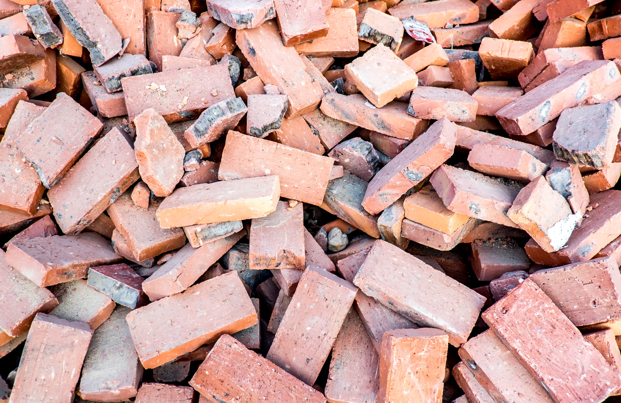 close up pile of orange brick at construction site 2021 10 27 19 29 25 utc scaled