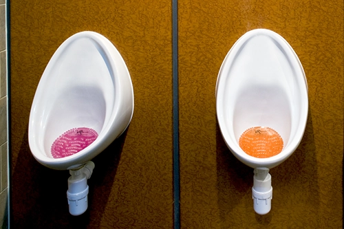Image of urinals with urinal screens in the basins feminine-and-sanitary-hygiene-waste-collection
